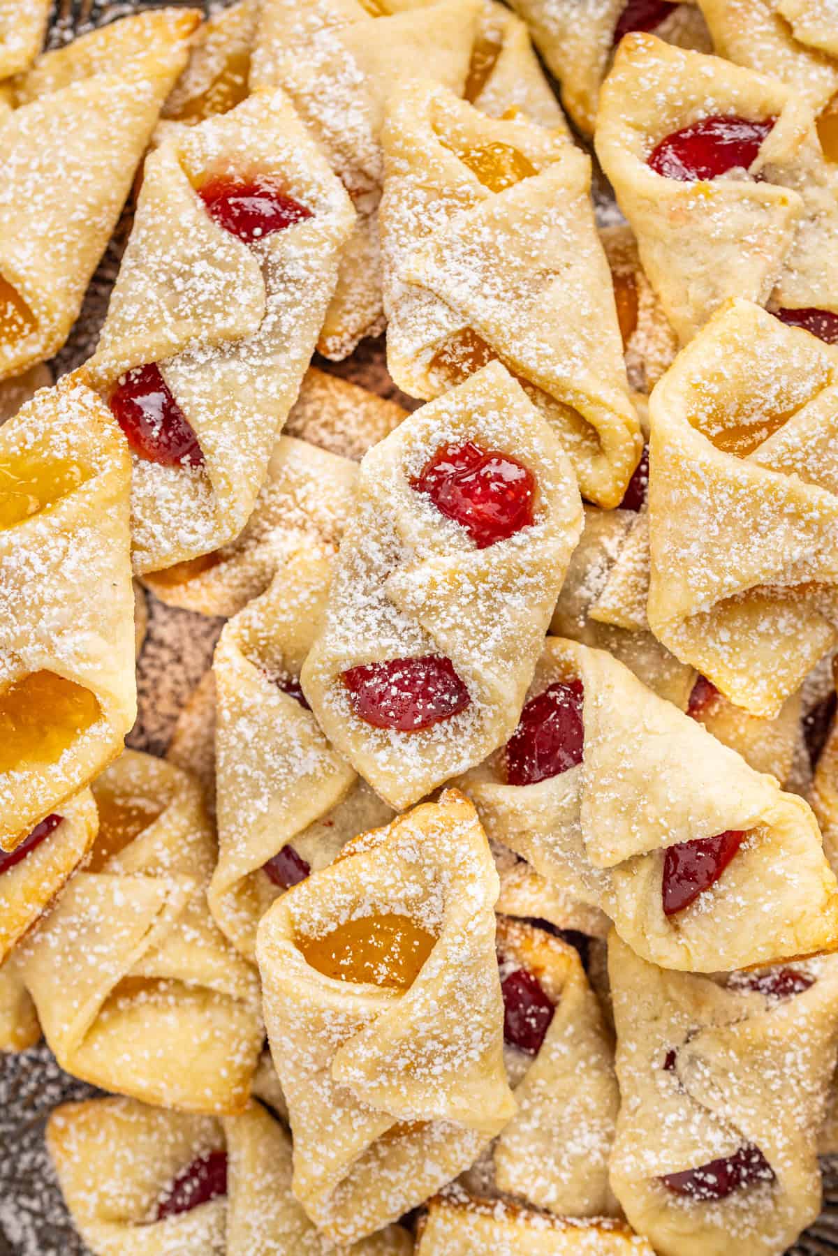 Kolaczki Cookies, aka Polish filled cookies, are made with a simple cream cheese dough and jam filling. They’re simple yet beautiful. Overhead view of a platter of kolaczki cookies