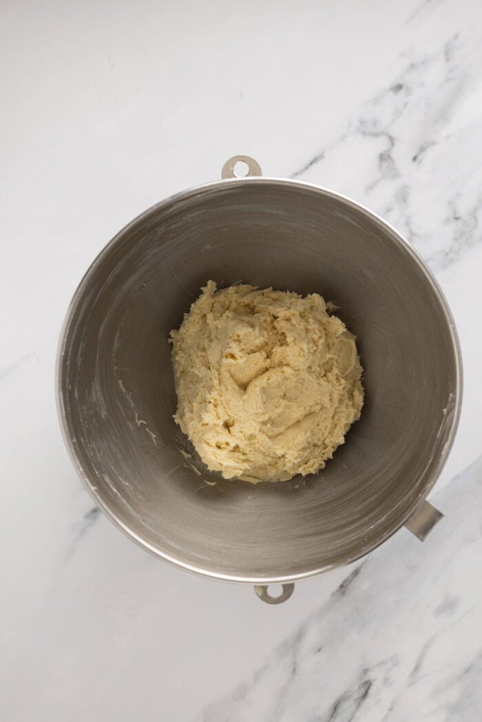 Kolaczki Cookies, aka Polish filled cookies, are made with a simple cream cheese dough and jam filling. They’re simple yet beautiful. A ball of cookie dough in a bowl