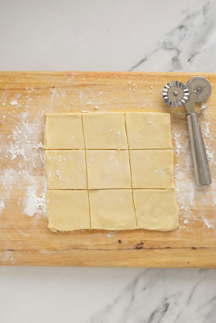 Kolaczki Cookies, aka Polish filled cookies, are made with a simple cream cheese dough and jam filling. They’re simple yet beautiful. Cookie dough rolled into a square and cut into smaller squares