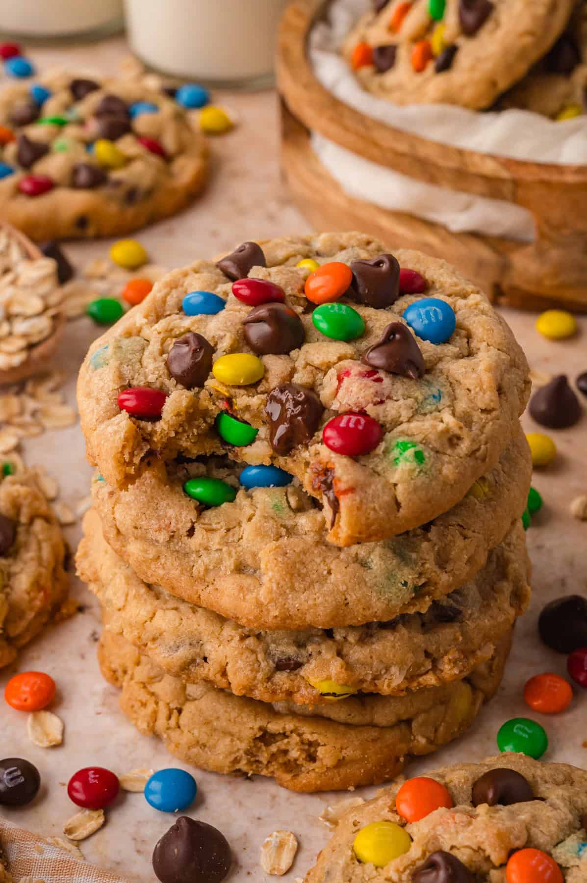 A stack of three monster cookies, the top one with a bite missing