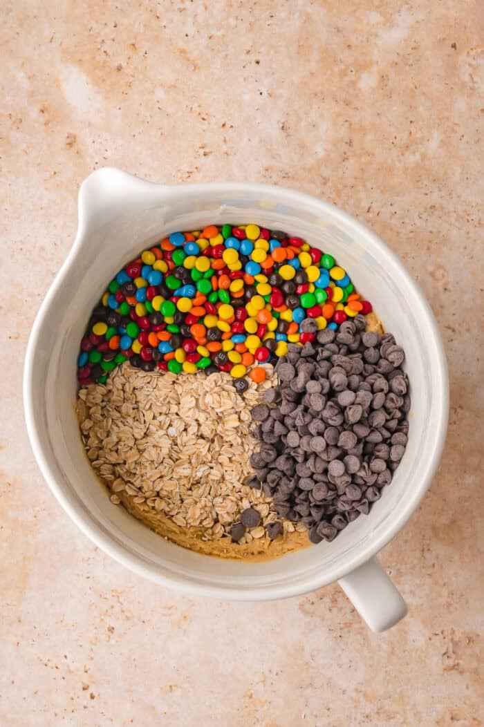 Oats, M&Ms, and chocolate chips added to cookie dough