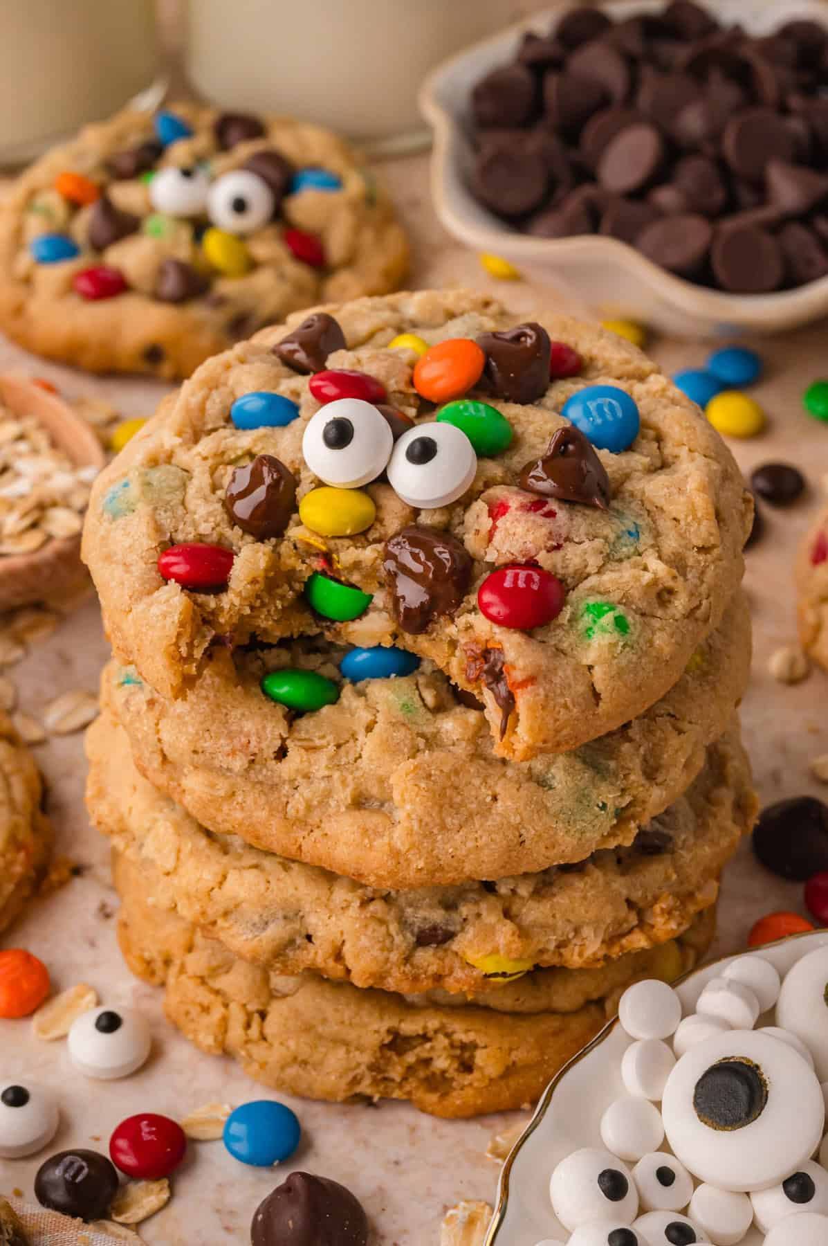 A stack of monster cookies, one with candy eyes