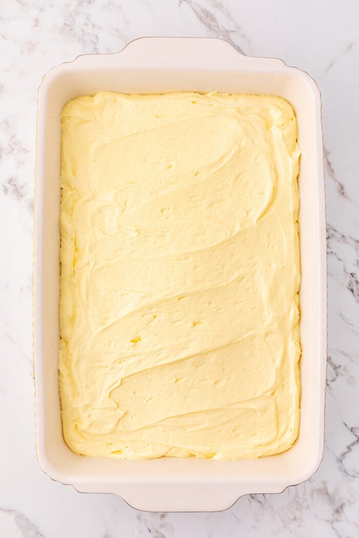 Cream cheese pudding mixture spread in a baking dish