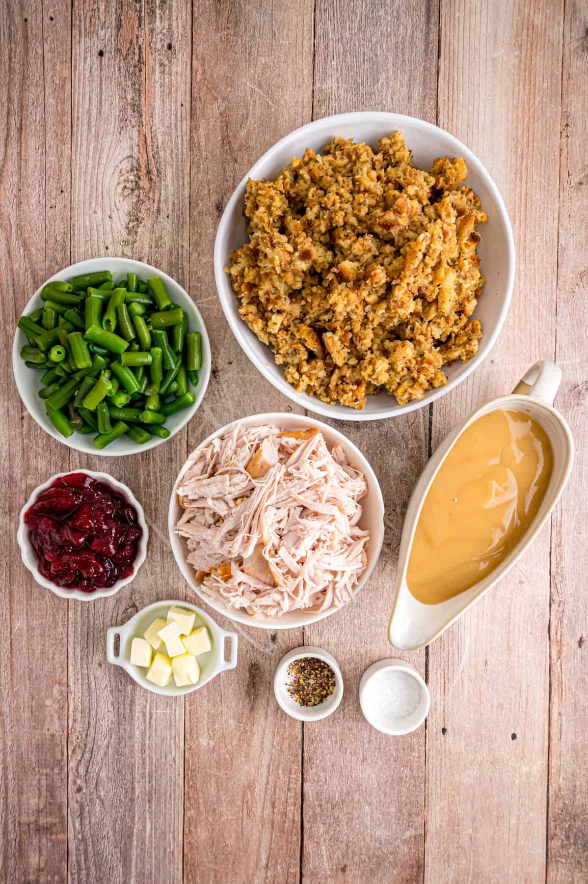 Turkey Stuffing Casserole is an easy way to repurpose Thanksgiving leftovers like turkey, gravy, cranberry sauce, and stuffing. Overhead view of ingredients needed to make turkey stuffing casserole