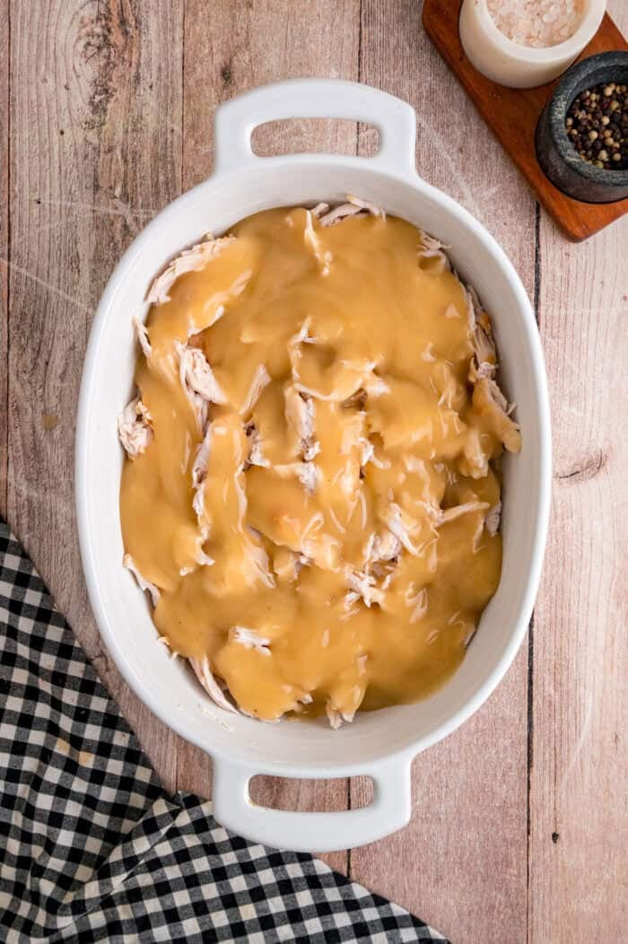 Turkey Stuffing Casserole is an easy way to repurpose Thanksgiving leftovers like turkey, gravy, cranberry sauce, and stuffing. Turkey and gravy in a baking dish