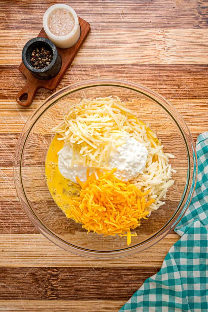 Eggs, shredded cheese, and cottage cheese in a bowl