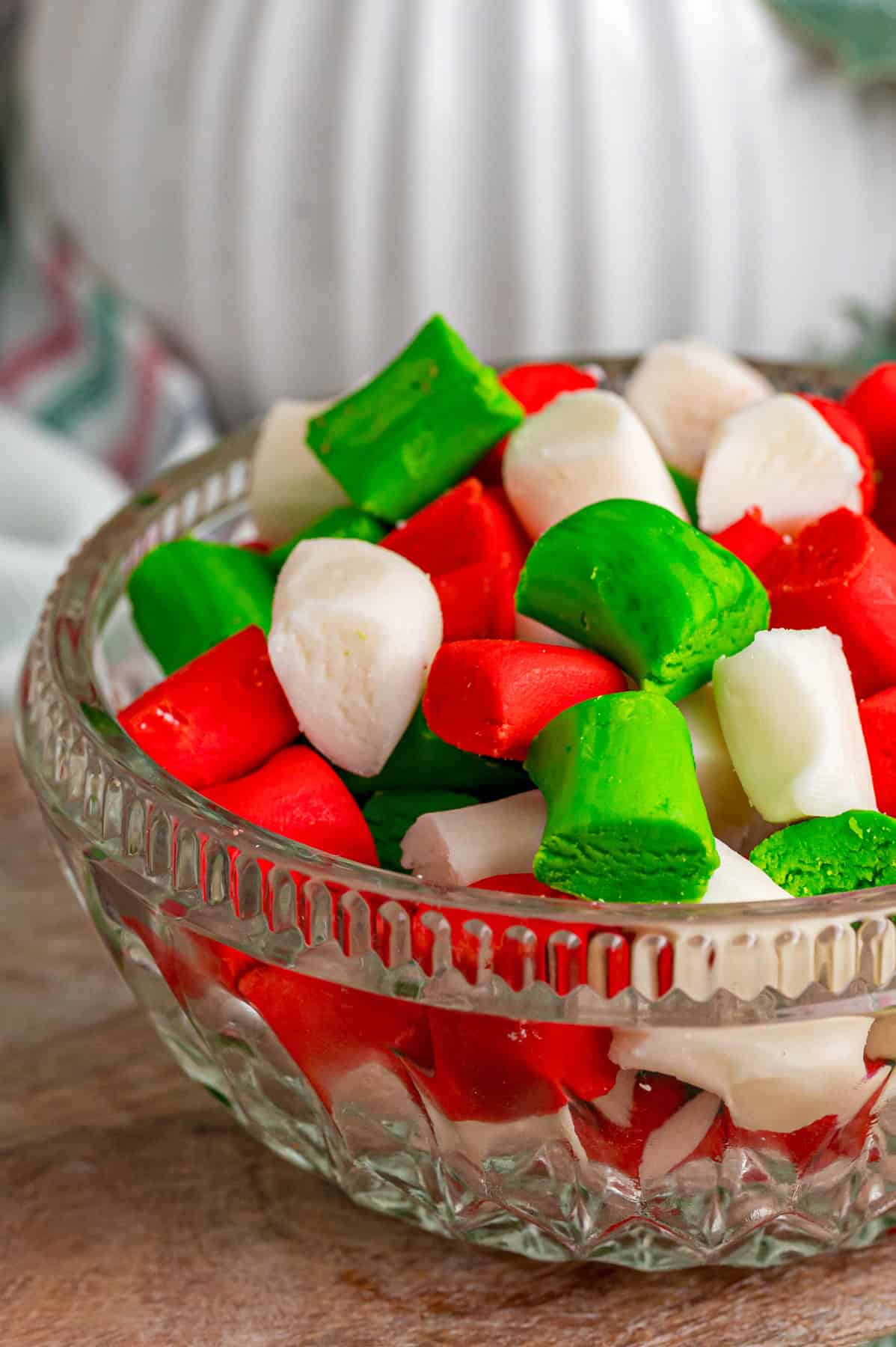 These melt-in-your-mouth Butter Mints are made with just a few ingredients and require no cooking. Easy to customize! A bowl of Christmas butter mints