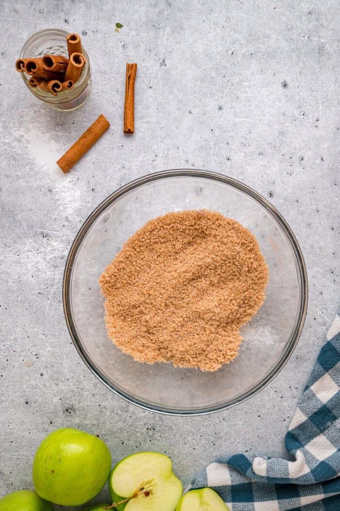 These Southern Fried Apples are warmly spiced, tender, and coated in a yummy brown sugar syrup. Enjoy with ice cream! Cinnamon sugar in a bowl