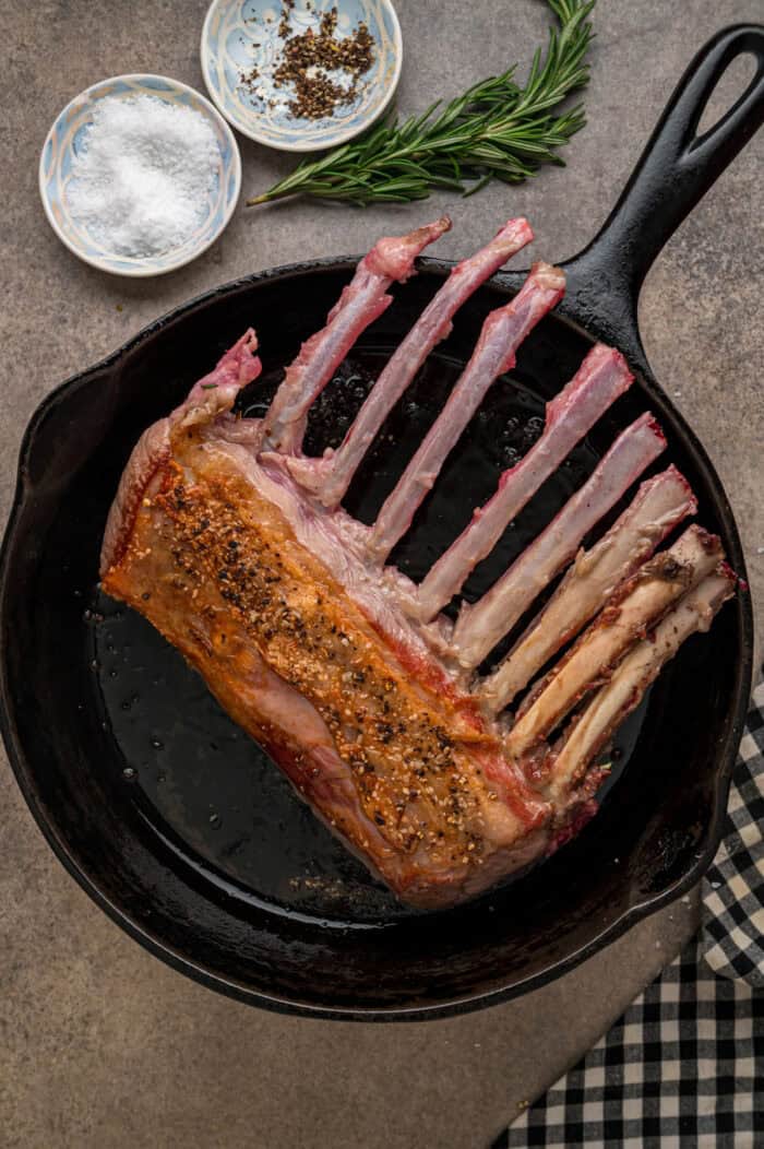 Seared rack of lamb in a skillet