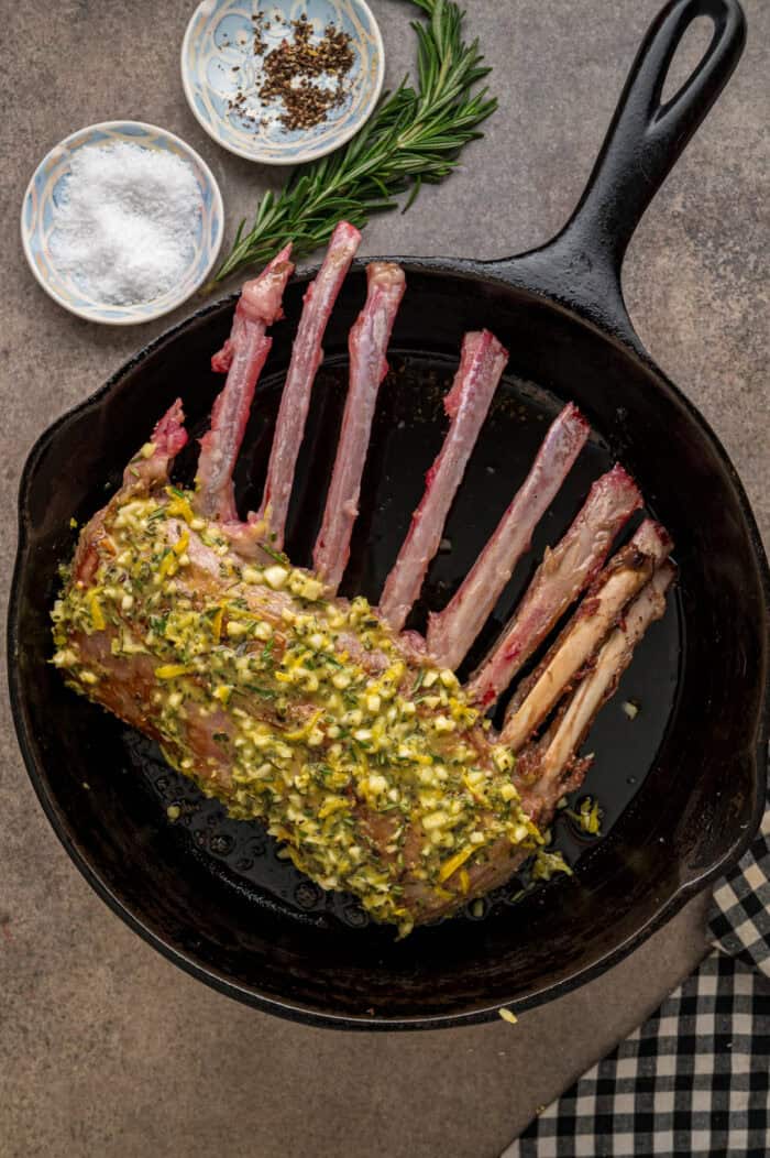 Seasoned rack of lamb in a skillet