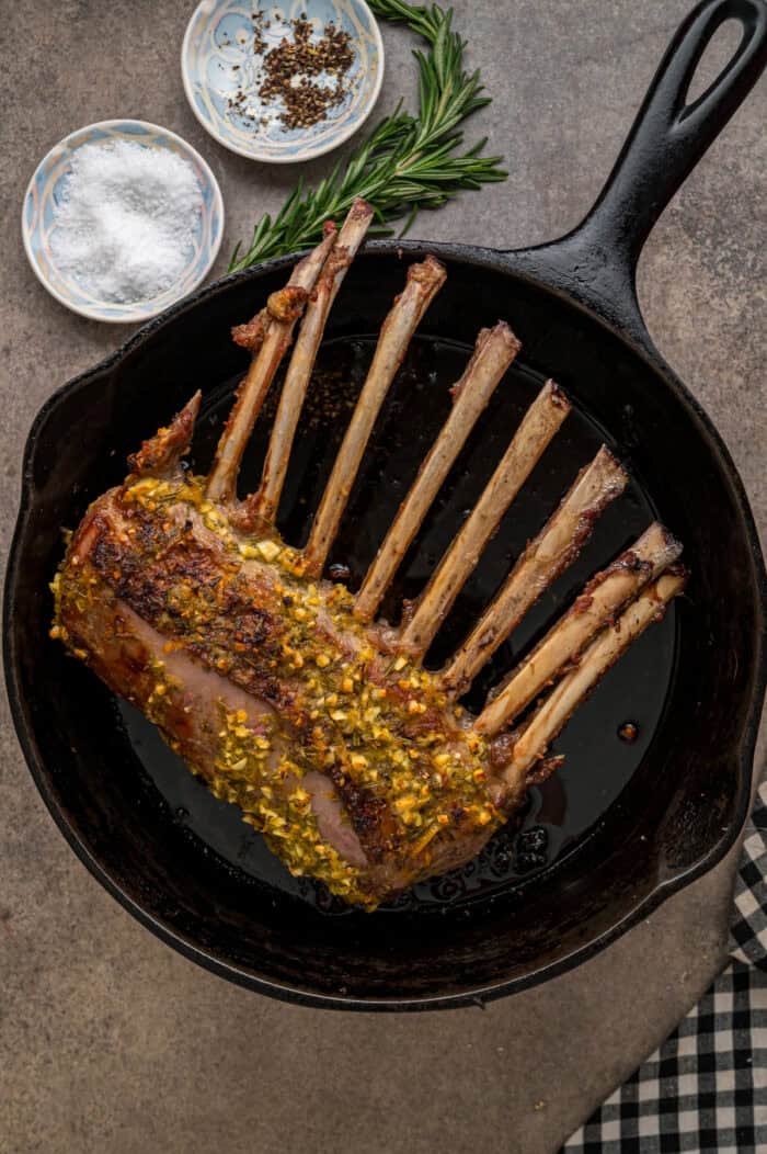Fully cooked rack of lamb in a cast iron skillet