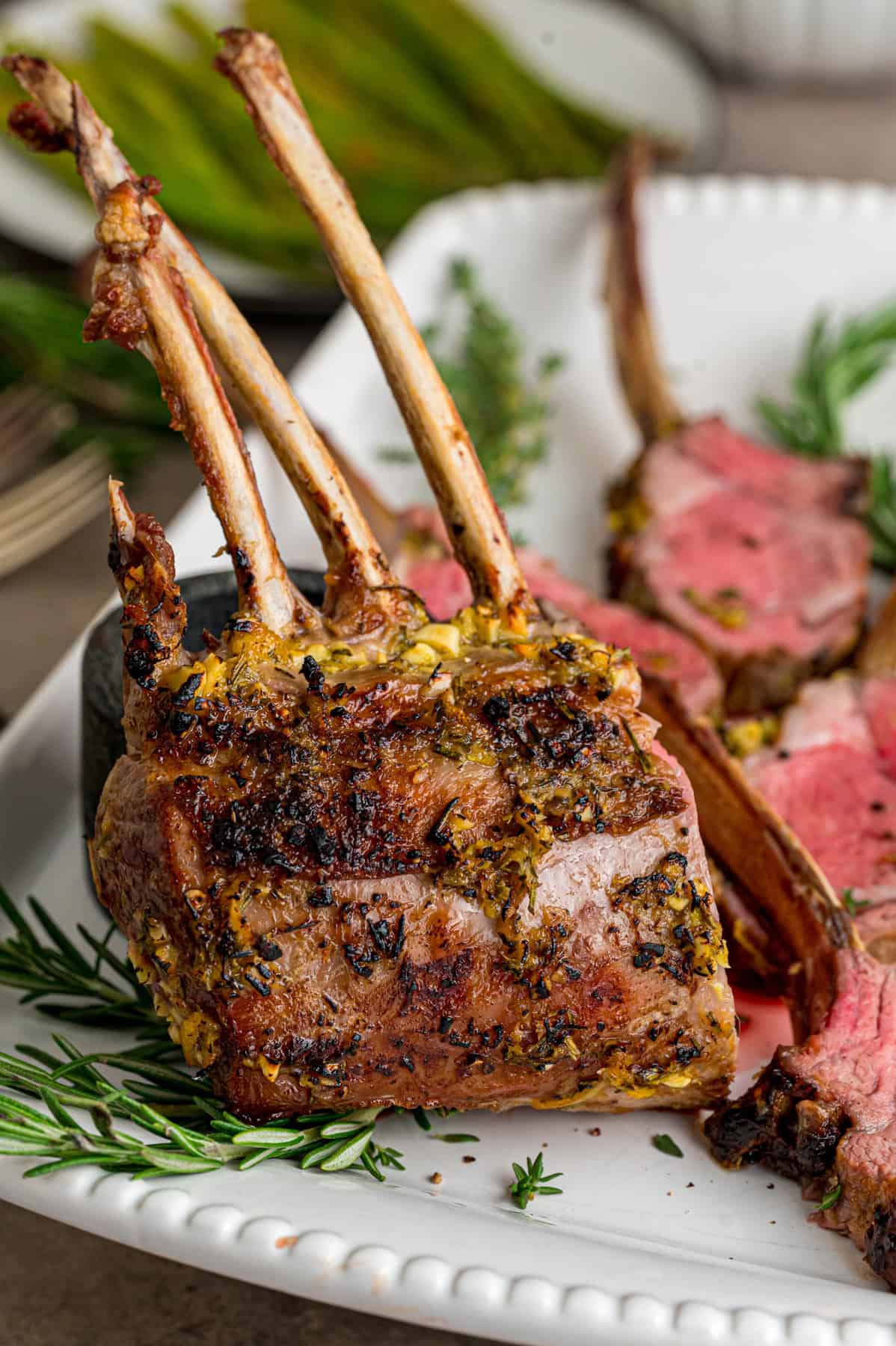A rack of lamb on a white plate