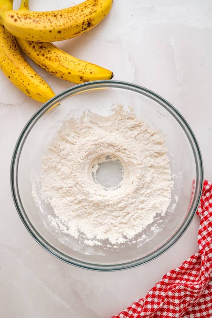 Every bite of these Banana Chocolate Chip Pancakes is dotted with chocolate chips and filled with sweet banana flavor. Dry pancake ingredients with a well in the center