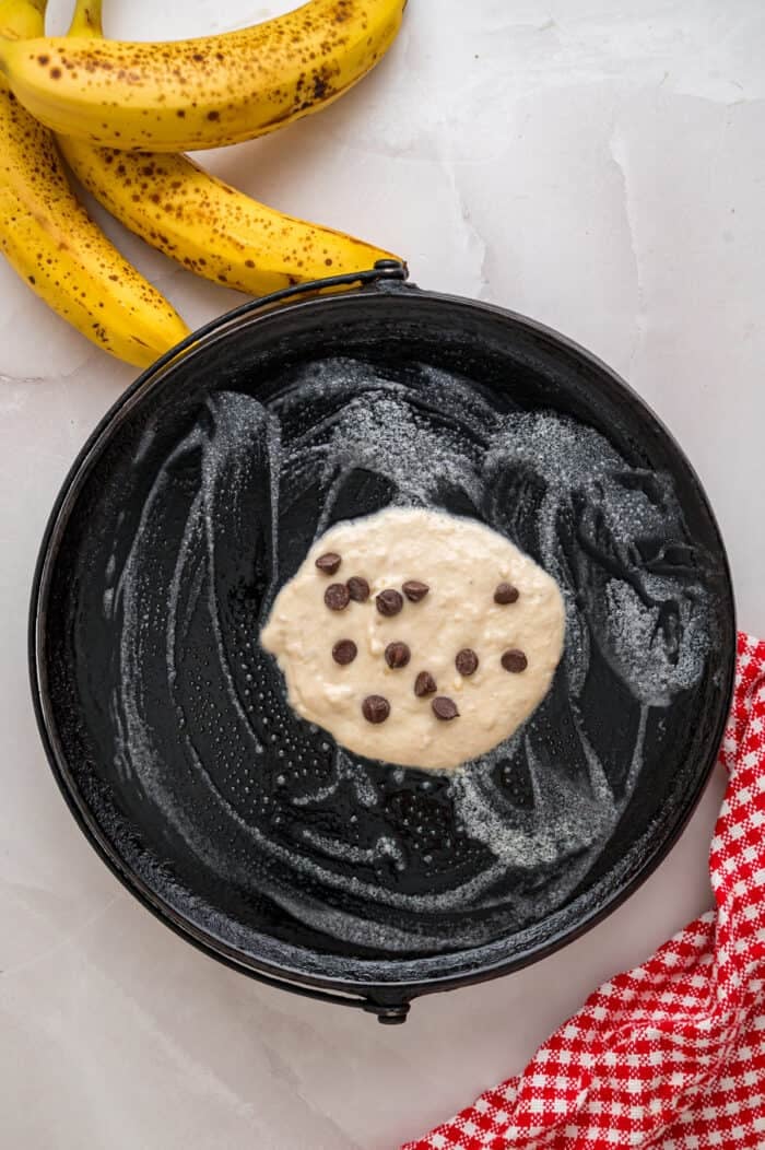 Every bite of these Banana Chocolate Chip Pancakes is dotted with chocolate chips and filled with sweet banana flavor. A banana chocolate chip pancake on the griddle