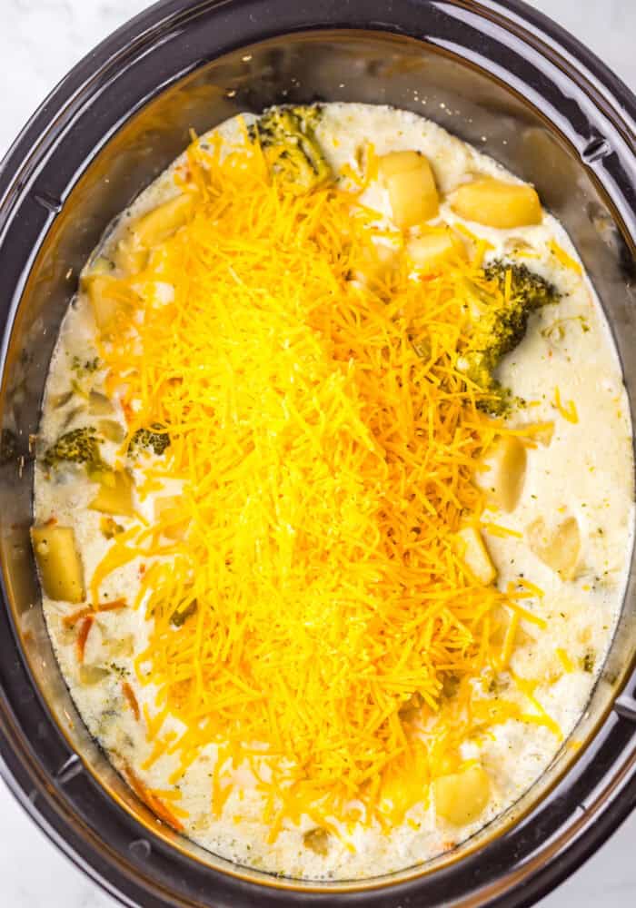 Shredded cheese on top of soup in the slow cooker