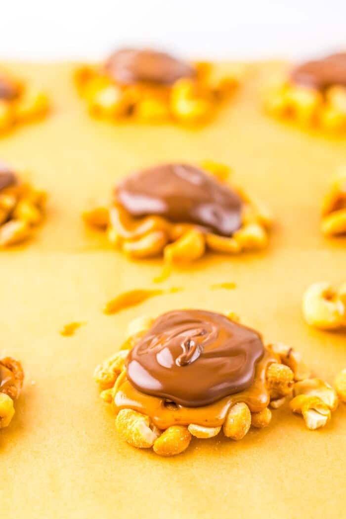 Caramel cashew clusters on a baking sheet