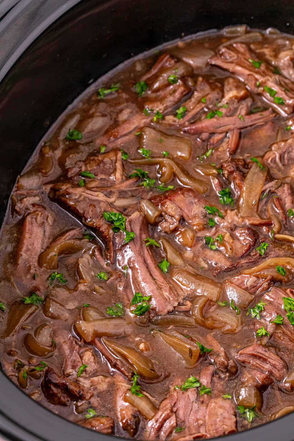 Seared chuck roast is slow cooked in savory broth and onion soup mix until fall-apart tender in this Slow Cooker French Onion Pot Roast. French onion pot roast in the slow cooker