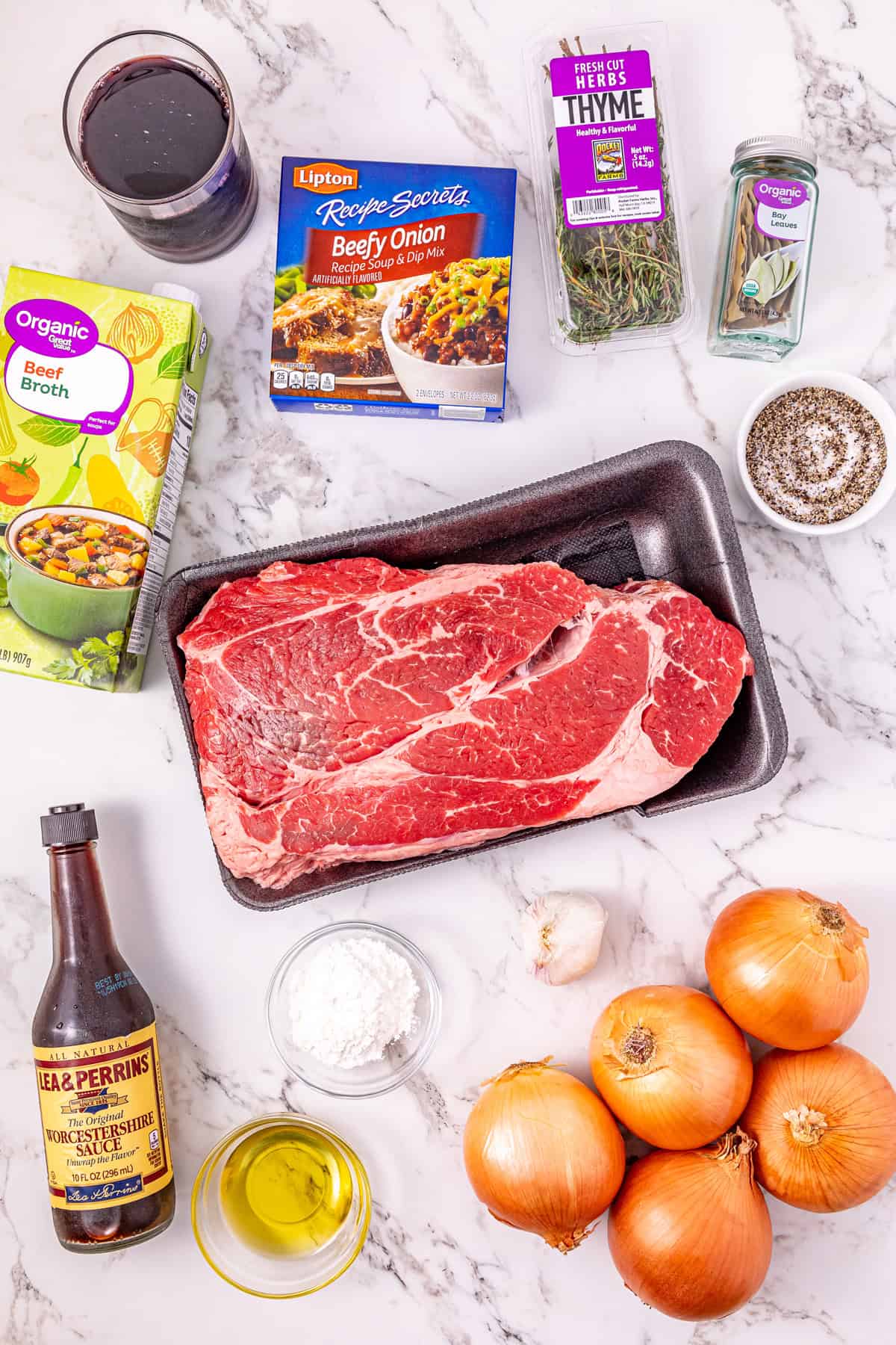 Seared chuck roast is slow cooked in savory broth and onion soup mix until fall-apart tender in this Slow Cooker French Onion Pot Roast. Overhead view of ingredients needed to make slow cooker French onion pot roast