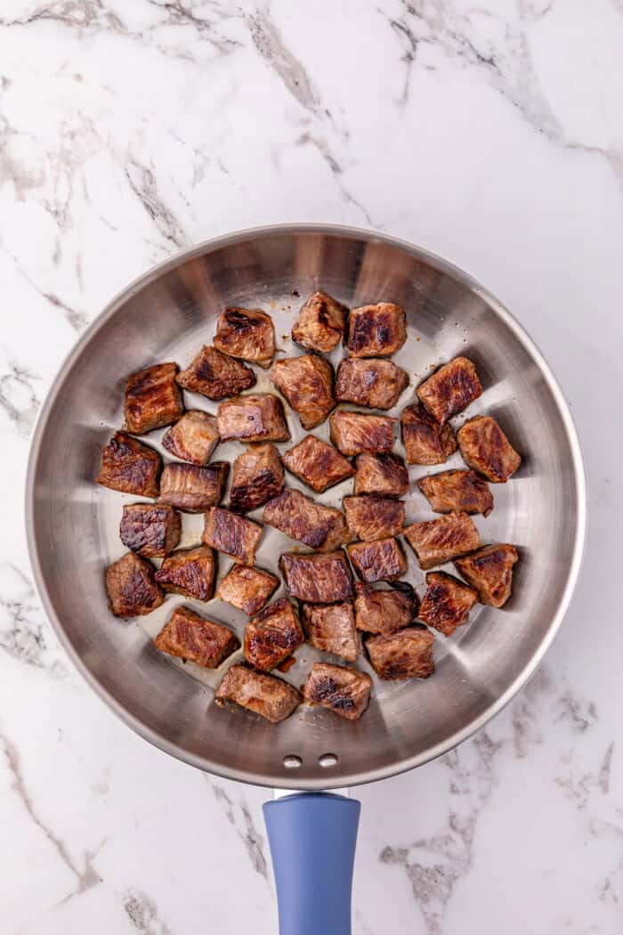 These Mississippi Steak Bites are savory, tangy, and so tender, with chunks of sirloin with ranch seasoning, au jus gravy, and pepperoncini. Seared chunks of sirloin in a skillet