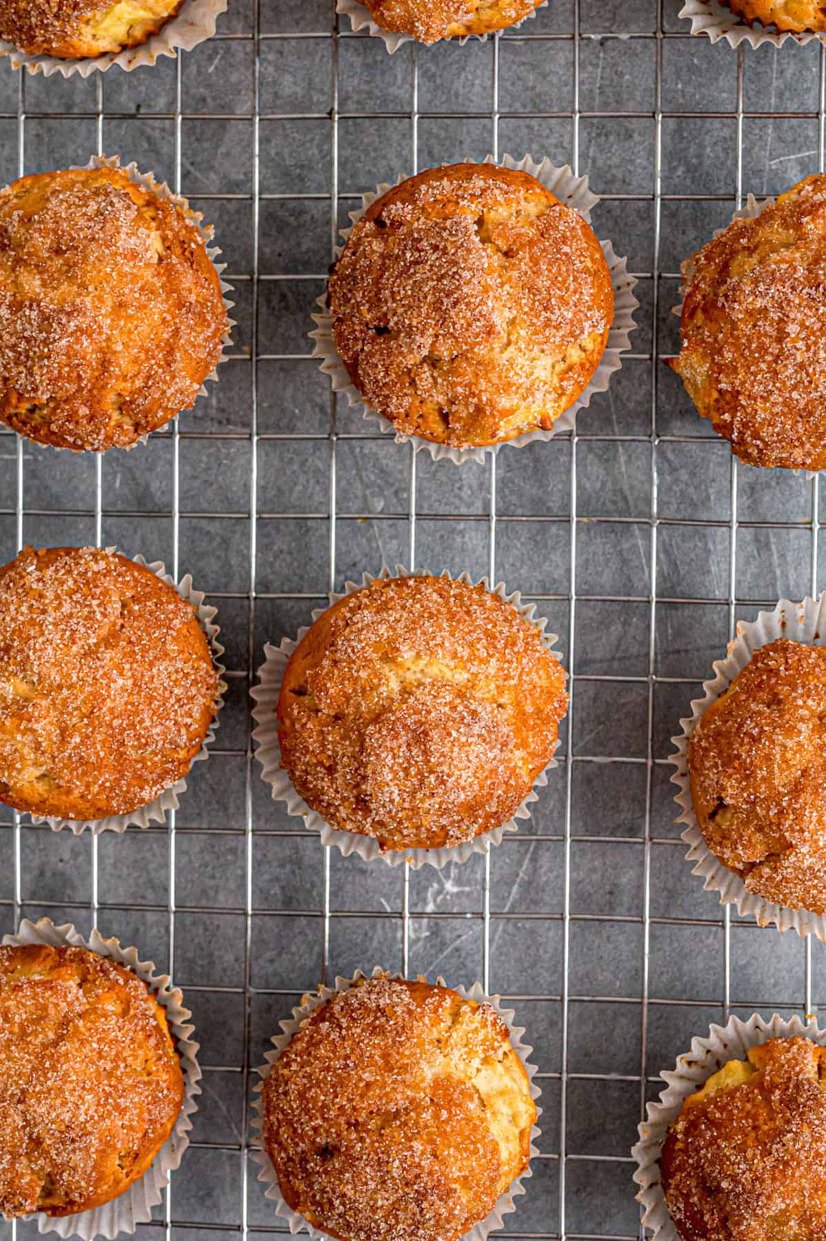 Each bite of these Applesauce Muffins is incredibly moist and infused with warm apple flavor. They look like something straight from a bakery! Overhead view of applesauce muffins on a cooling rack