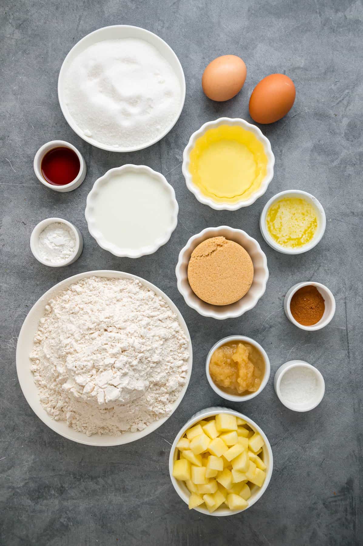 Each bite of these Applesauce Muffins is incredibly moist and infused with warm apple flavor. They look like something straight from a bakery! Overhead view of ingredients needed to make applesauce muffins