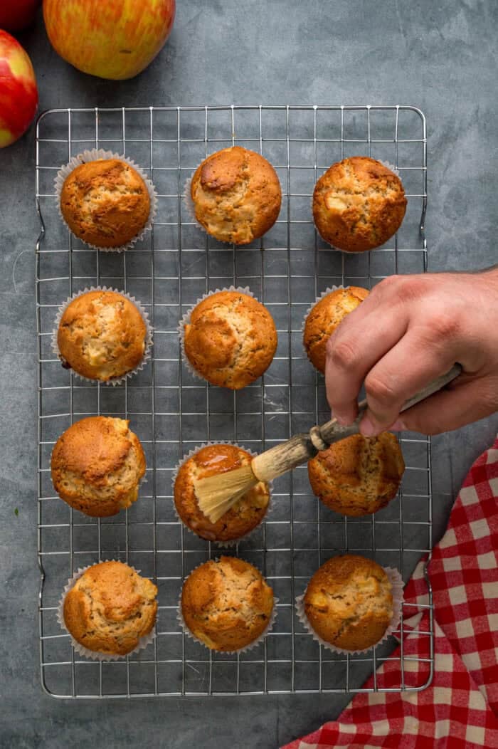 Each bite of these Applesauce Muffins is incredibly moist and infused with warm apple flavor. They look like something straight from a bakery! Brushing applesauce muffins with butter