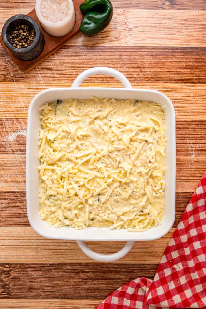 Eggs poured over layers of peppers and cheese