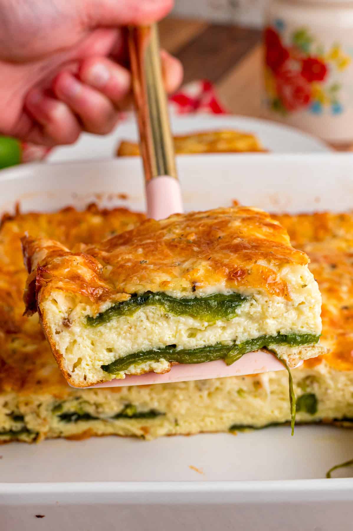 A slice of chile relleno casserole on a spatula