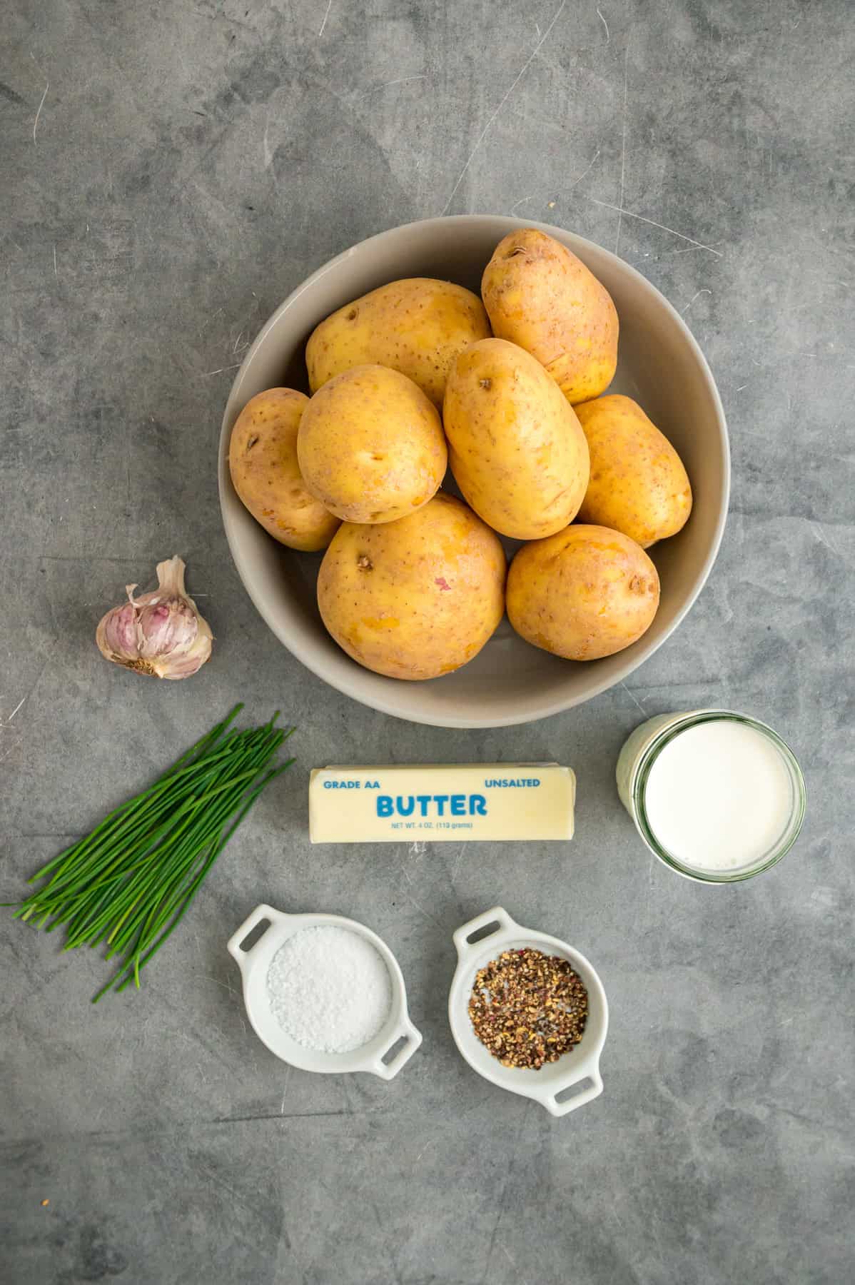 Overhead view of ingredients needed to make garlic mashed potatoes