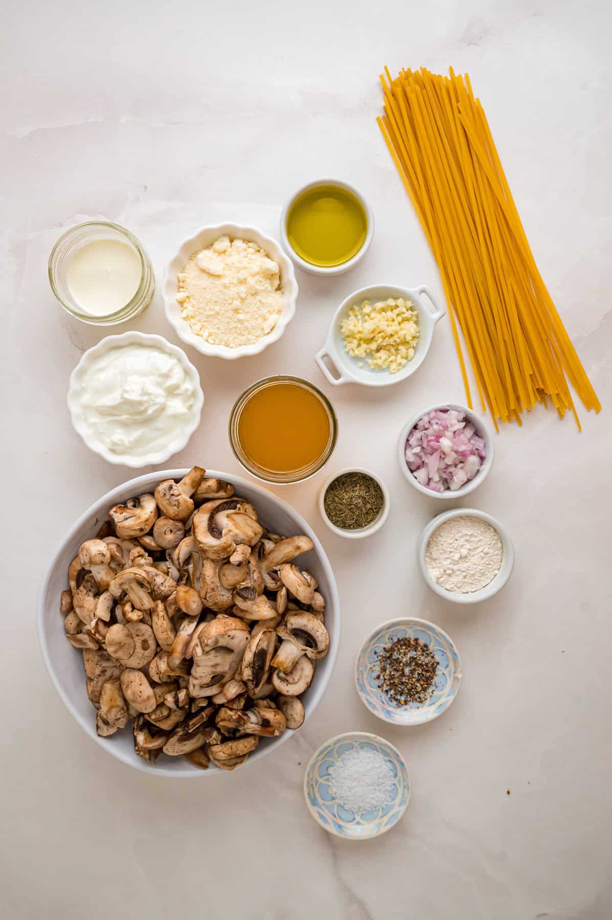 Ready in just 35 minutes, this Creamy Mushroom Pasta looks like a fancy restaurant dish but is easy enough to whip up on busy weeknights. Overhead view of ingredients needed to make mushroom pasta