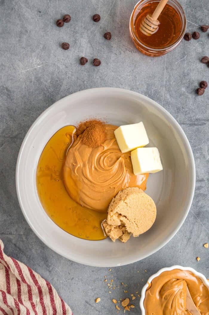 Sweet, nutty, and crunchy, this Peanut Butter Granola is better than anything that can be bought at the store! Honey, peanut butter, butter, and brown sugar in a bowl.