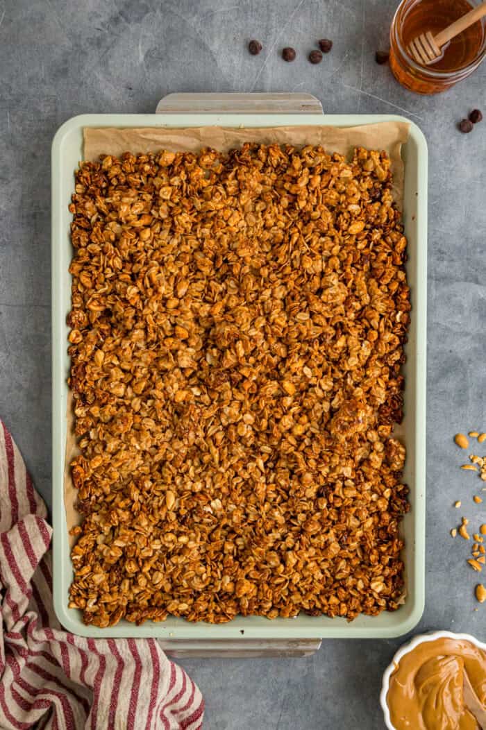Sweet, nutty, and crunchy, this Peanut Butter Granola is better than anything that can be bought at the store! Peanut butter coated oats spread on a baking sheet