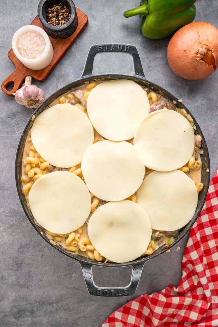 Loaded with sliced ribeye, peppers, onions, mushrooms, and lots of cheese, this Philly Cheesesteak Pasta is an easy one-pan dinner. Slices of provolone on pasta