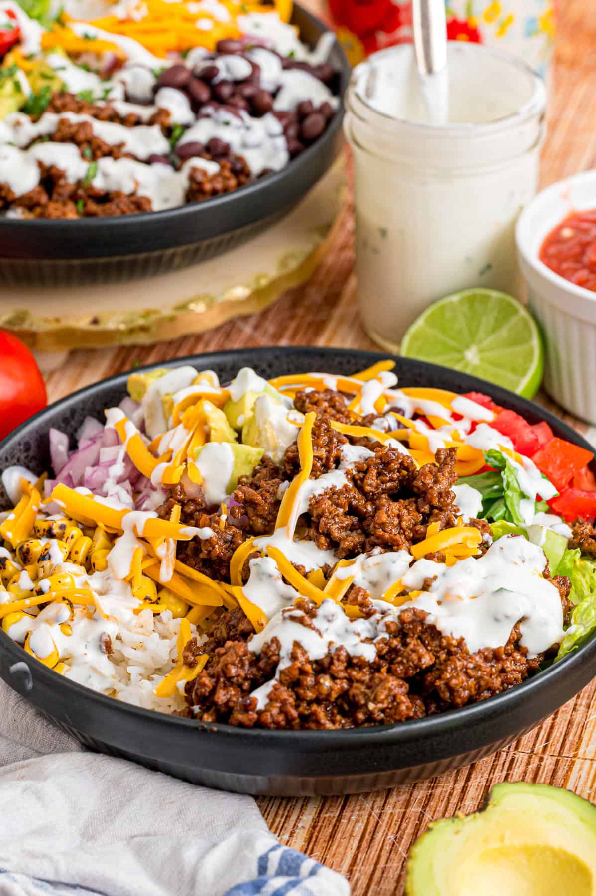Elevate Taco Tuesday with this easy Taco Bowl recipe. With seasoned taco meat, rice and cilantro lime crema, it's an easy weeknight dinner. Overhead view of a taco bowl