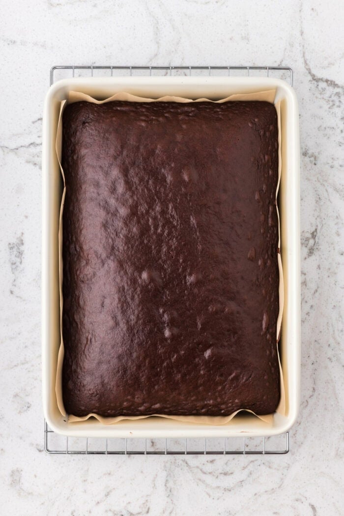 Rich devil’s food cake, cherry pie filling, and homemade whipped cream are layered to make this impressive yet easy Black Forest Trifle. Baked devil's food cake in a white baking pan