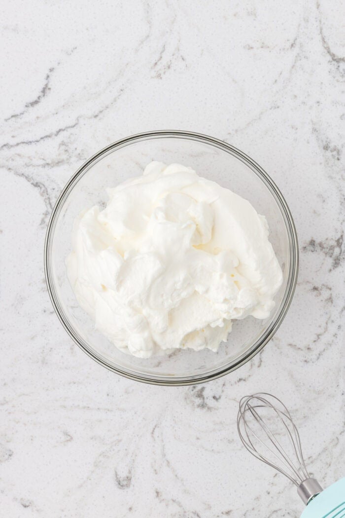 Rich devil’s food cake, cherry pie filling, and homemade whipped cream are layered to make this impressive yet easy Black Forest Trifle. Whipped cream in a bowl