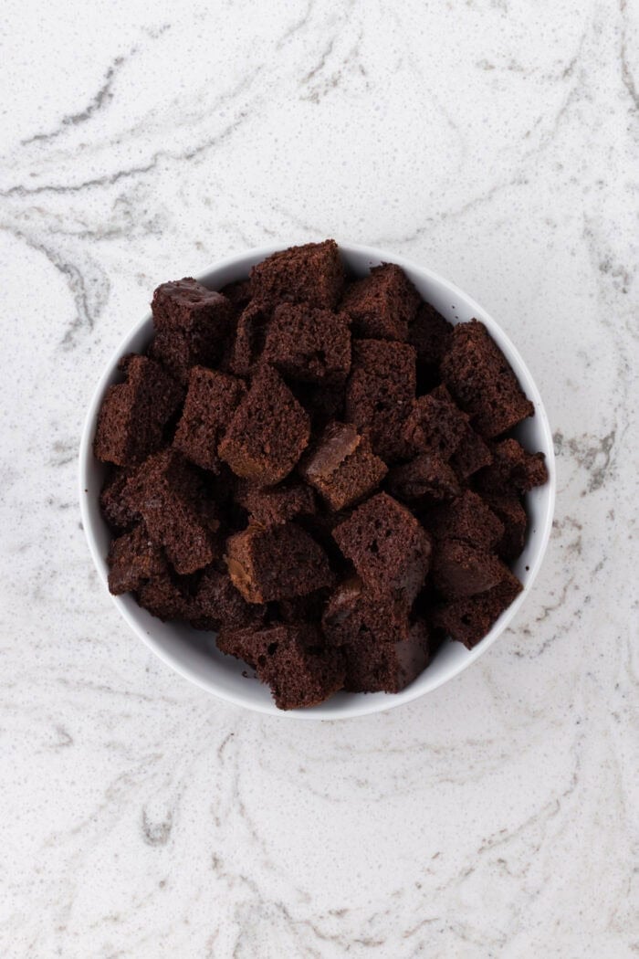 Rich devil’s food cake, cherry pie filling, and homemade whipped cream are layered to make this impressive yet easy Black Forest Trifle. Cubes of devil's food cake in a white bowl