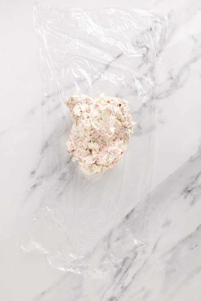 Salty dried beef combines with tangy cream cheese and sharp cheddar cheese to make this irresistible Chipped Beef Cheese Ball. Chipped beef cream cheese mixture wrapped in plastic