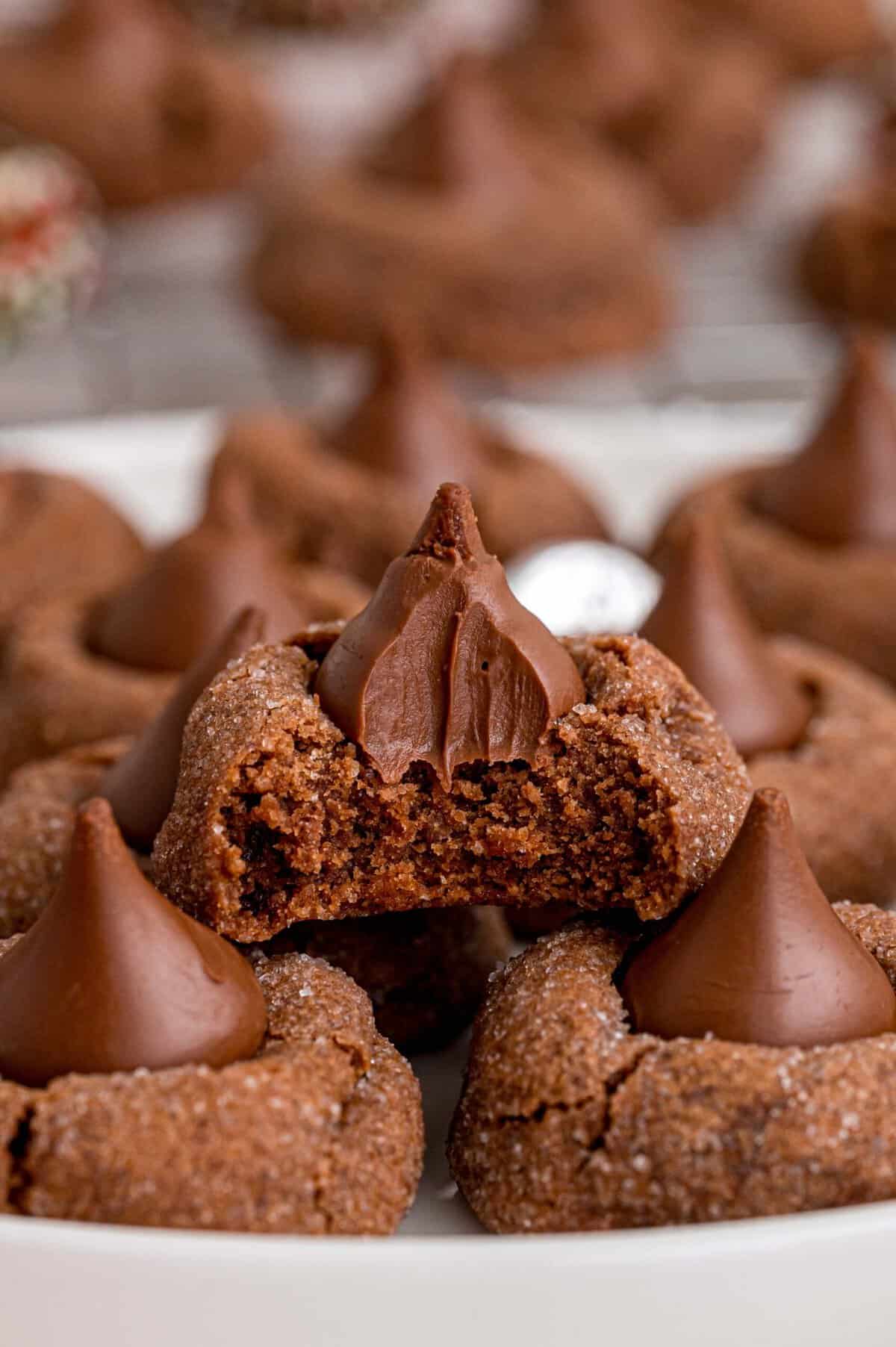 With chocolate kisses pressed in the center of chewy chocolate cookies, these Hershey Chocolate Kiss Cookies are made for chocolate lovers! Hershey kiss cookies, one with a bite missing