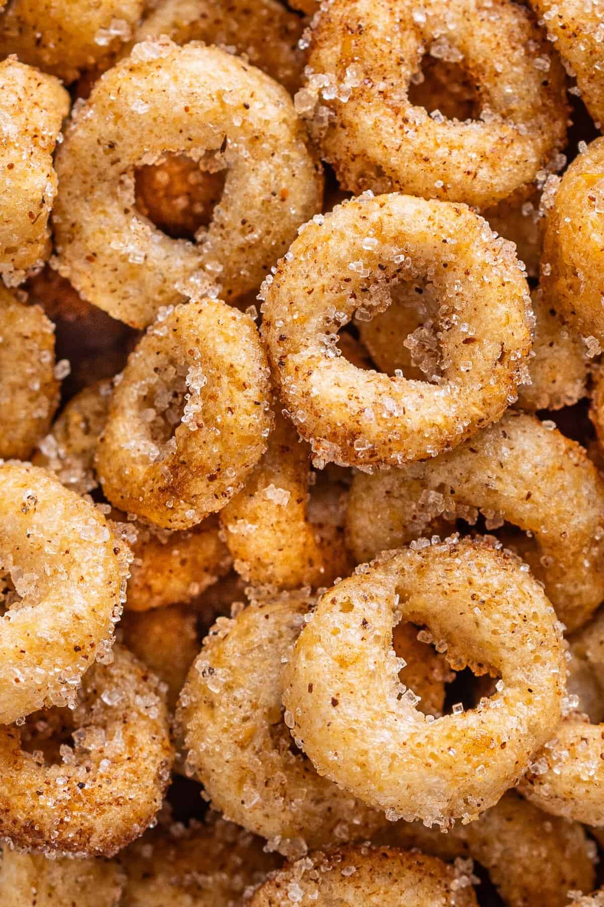 Hot Buttered Cheerios, aka Fried Cheerios, are a nostalgic snack featuring Cheerios toasted in butter and tossed with cinnamon sugar. Close up of hot buttered Cheerios to show the texture