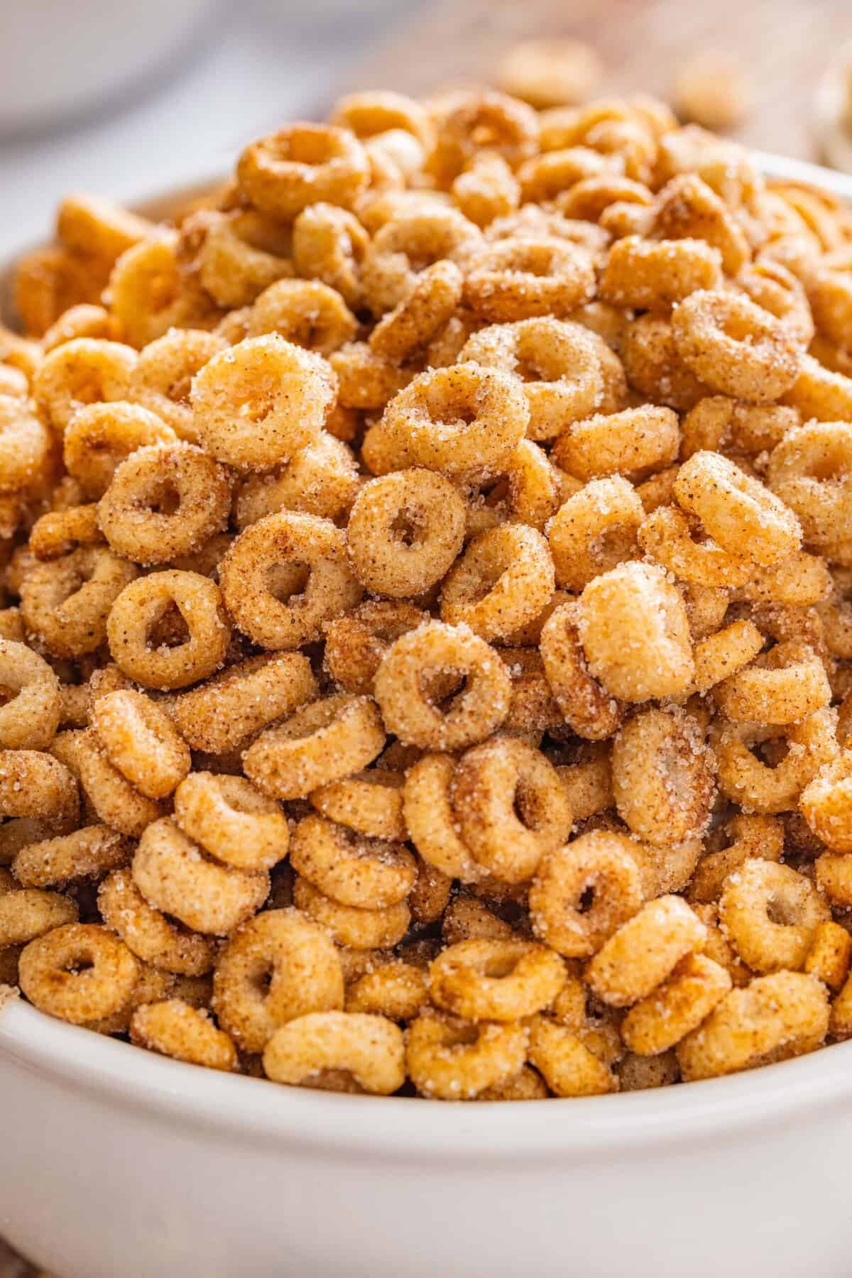 Hot Buttered Cheerios, aka Fried Cheerios, are a nostalgic snack featuring Cheerios toasted in butter and tossed with cinnamon sugar. A bowl of hot buttered Cheerios