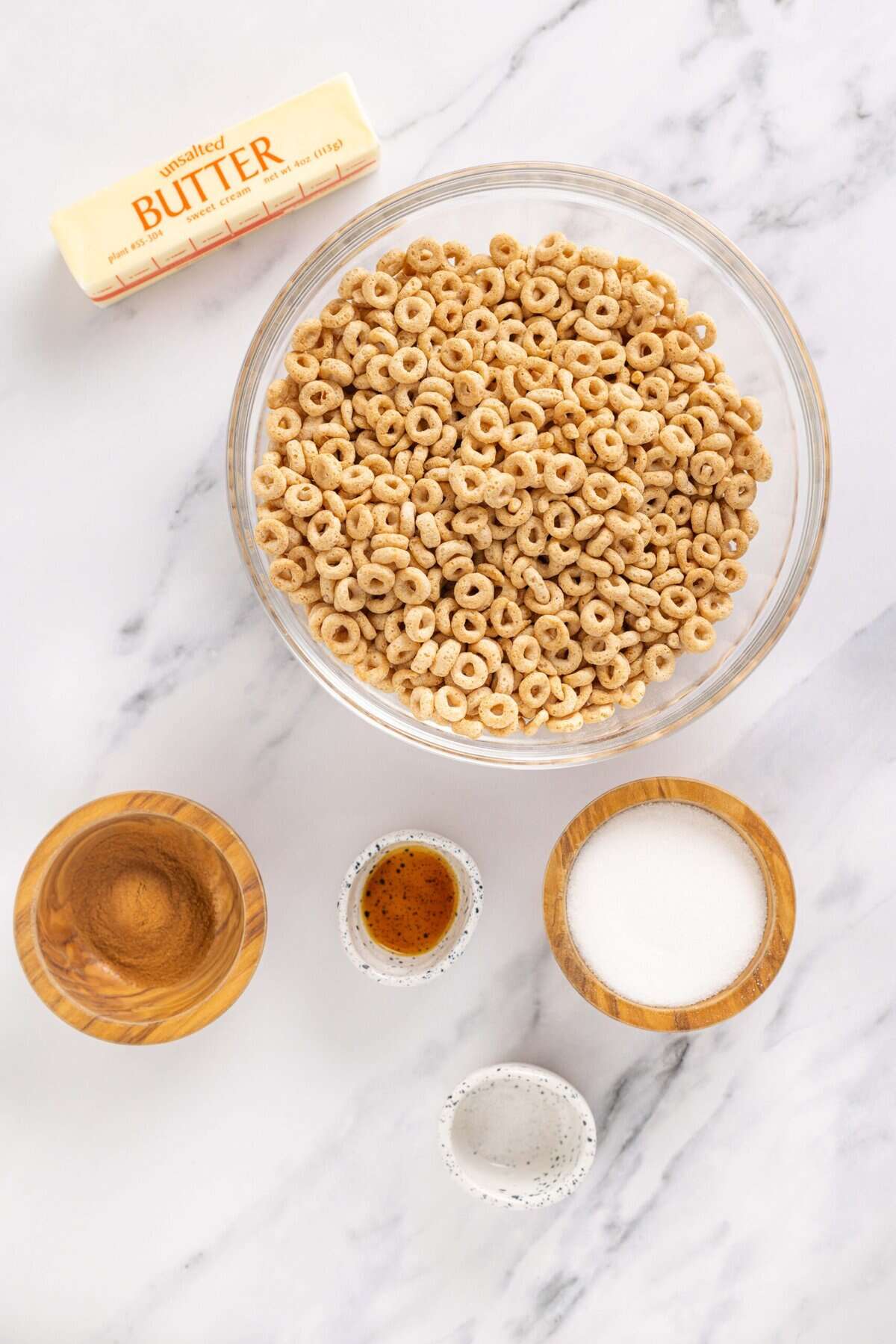 Hot Buttered Cheerios, aka Fried Cheerios, are a nostalgic snack featuring Cheerios toasted in butter and tossed with cinnamon sugar. Overhead view of ingredients needed to make hot buttered cheerios