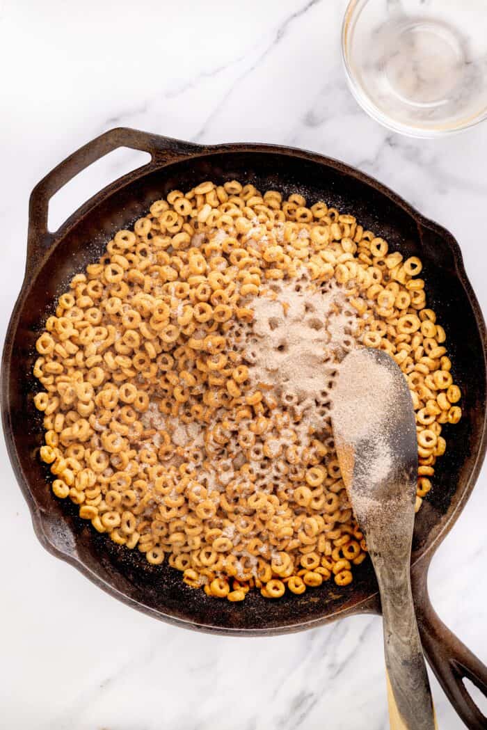 Hot Buttered Cheerios, aka Fried Cheerios, are a nostalgic snack featuring Cheerios toasted in butter and tossed with cinnamon sugar. Coating Cheerios with cinnamon sugar