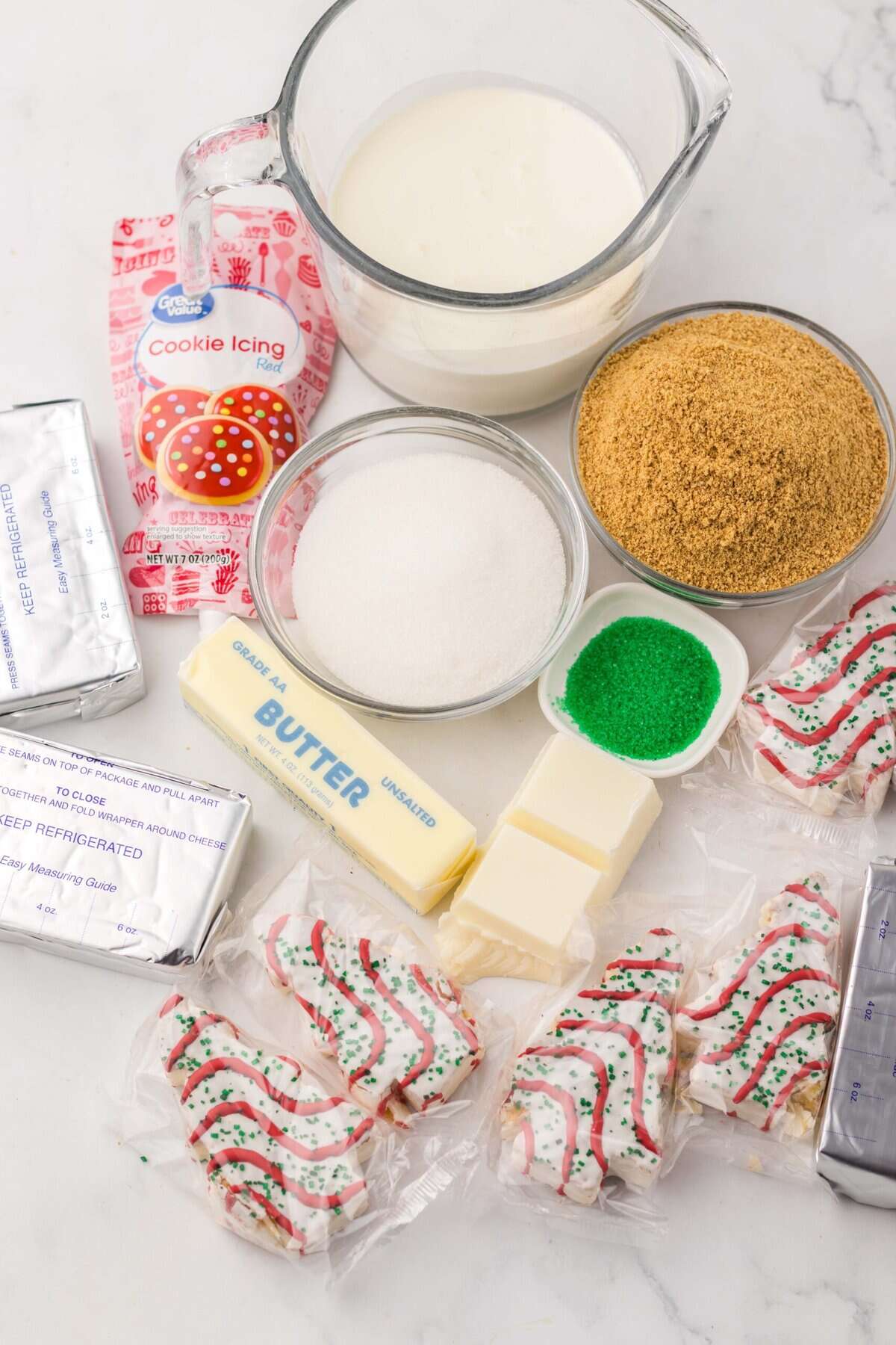 With no baking required, this Little Debbie Christmas Tree Cheesecake is a fun, festive, and nostalgic Christmas treat. Overhead view of ingredients needed to make Little Debbie Christmas Tree Cheesecake