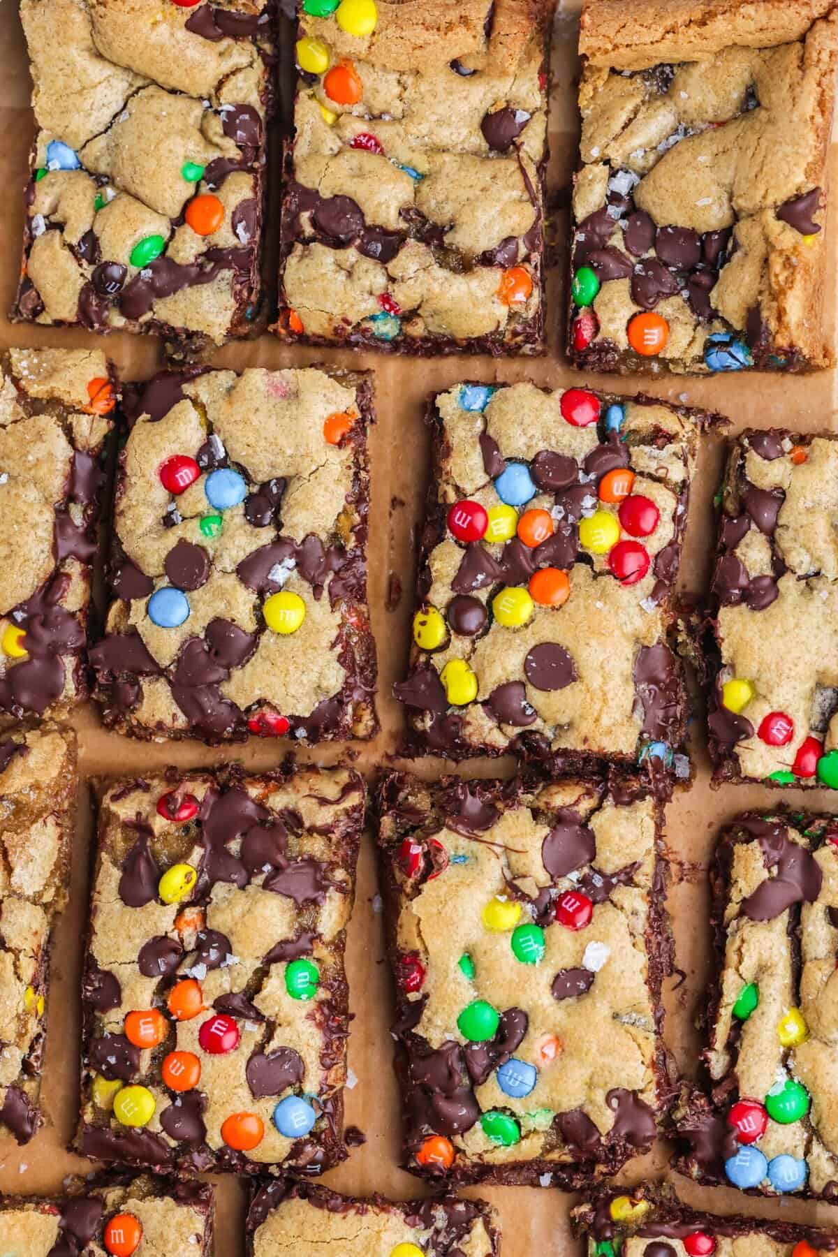Craving cookies but short on time? These M&M Cookie Bars are like baking a batch of thick, chewy cookies in one pan with 10 minutes of prep. Overhead view of sliced M&M cookie bars