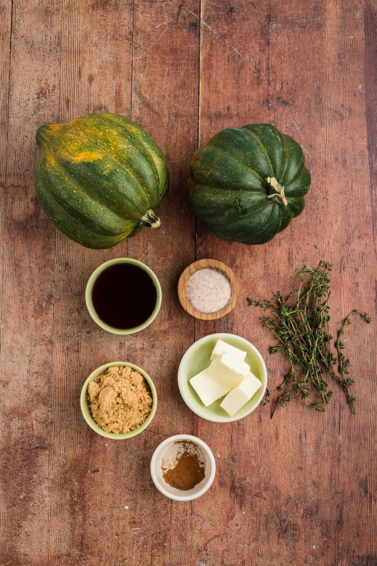 Squash is coated in a sweet, savory, and buttery glaze that caramelizes in the oven in this Maple Butter Roasted Acorn Squash recipe. Overhead view of ingredients needed to make roasted acorn squash