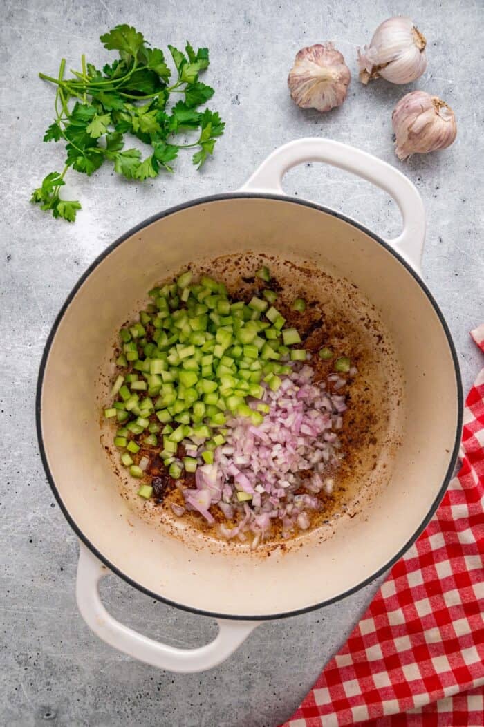 Tender chunks of beef are cooked in a rich, savory gravy and served over egg noodles in this easy Beef and Noodles recipe. Celery and onion in a Dutch oven