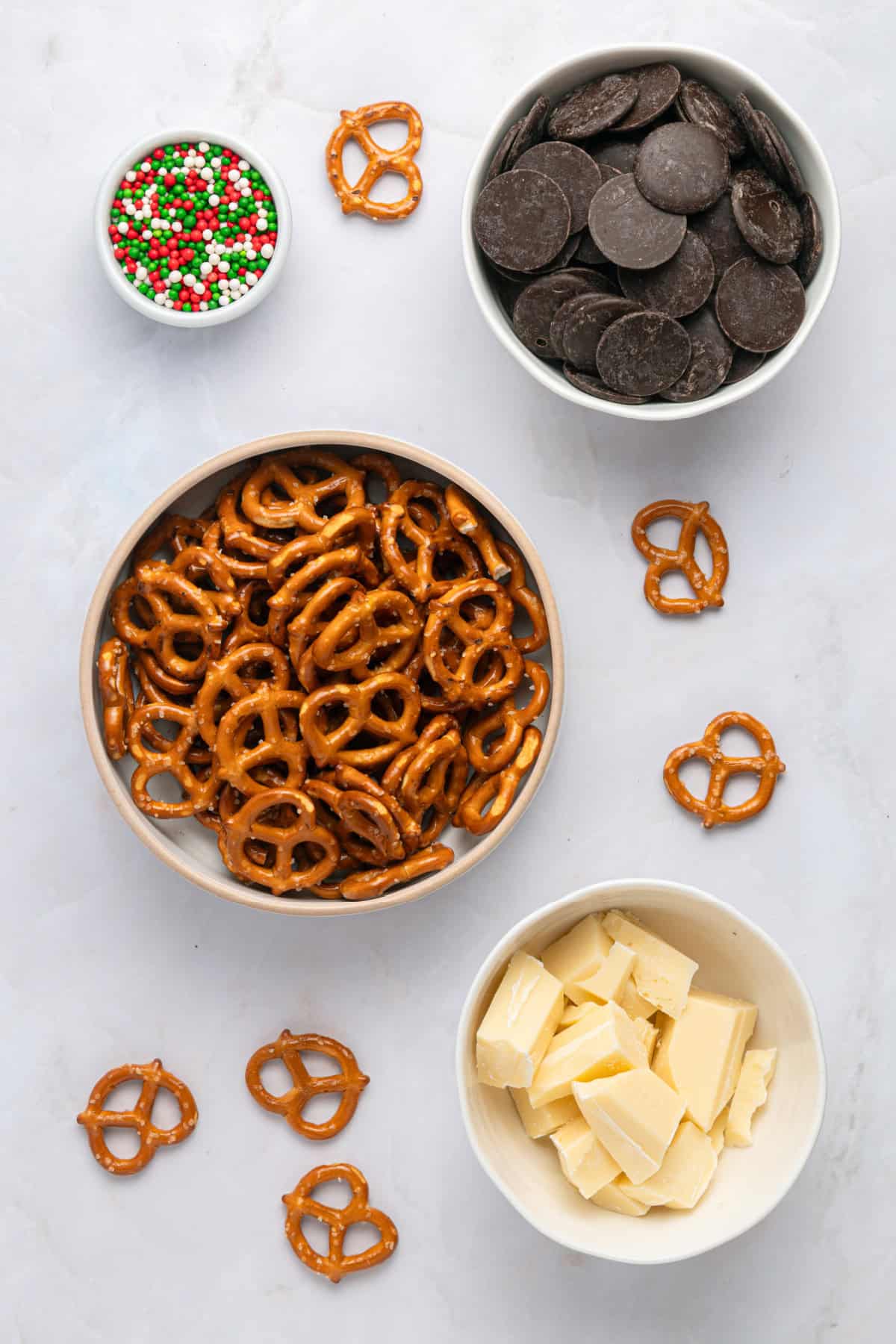 These Chocolate Covered Pretzels are made with pretzel twists coated in dark and white chocolate and decorated with sprinkles. ingredients for chocolate covered pretzels