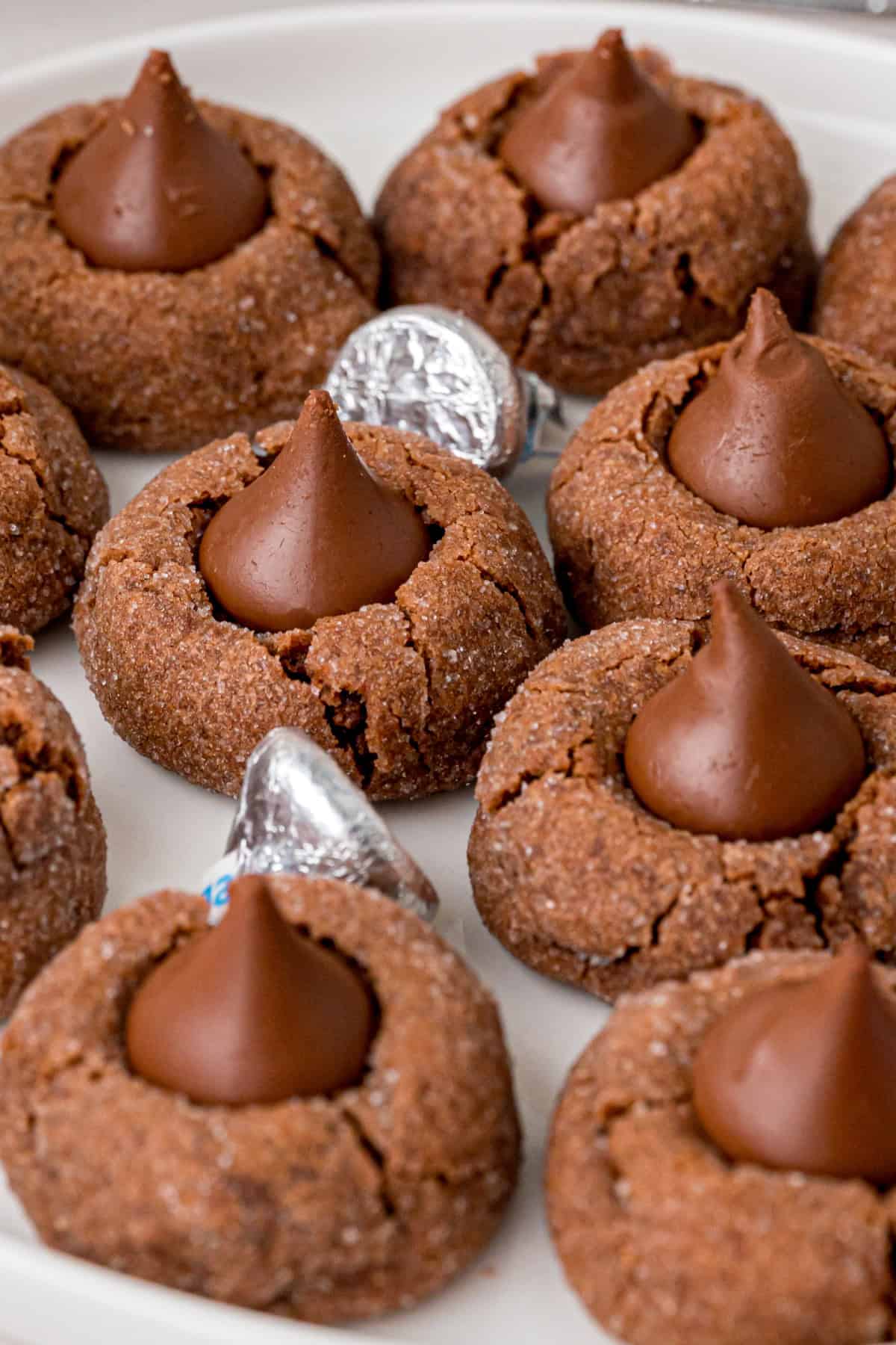 With chocolate kisses pressed in the center of chewy chocolate cookies, these Hershey Chocolate Kiss Cookies are made for chocolate lovers! Chocolate Kiss Cookies on a white plate