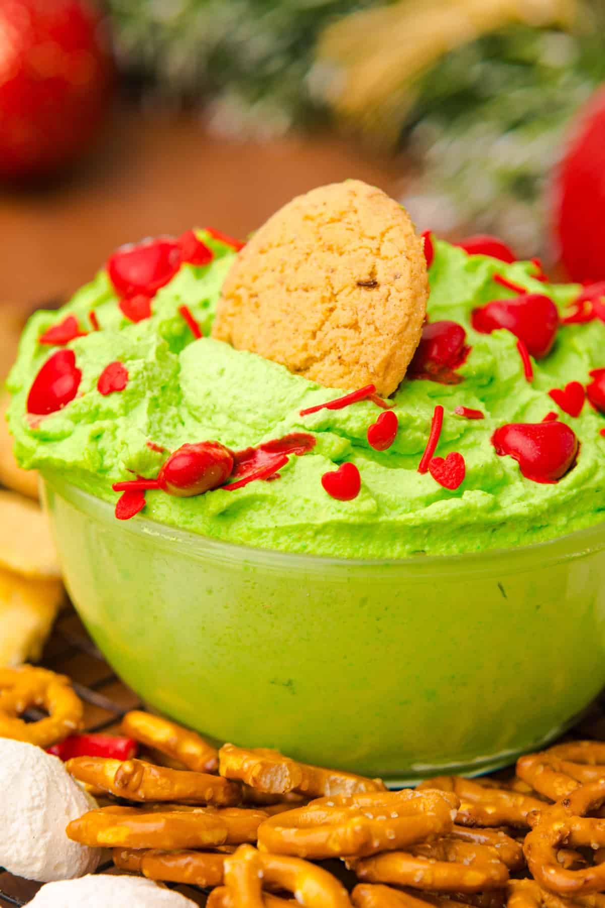 A cookie dipped into Grinch Dip